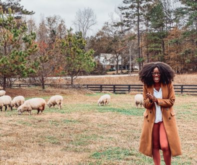 black girl laughing with sheep